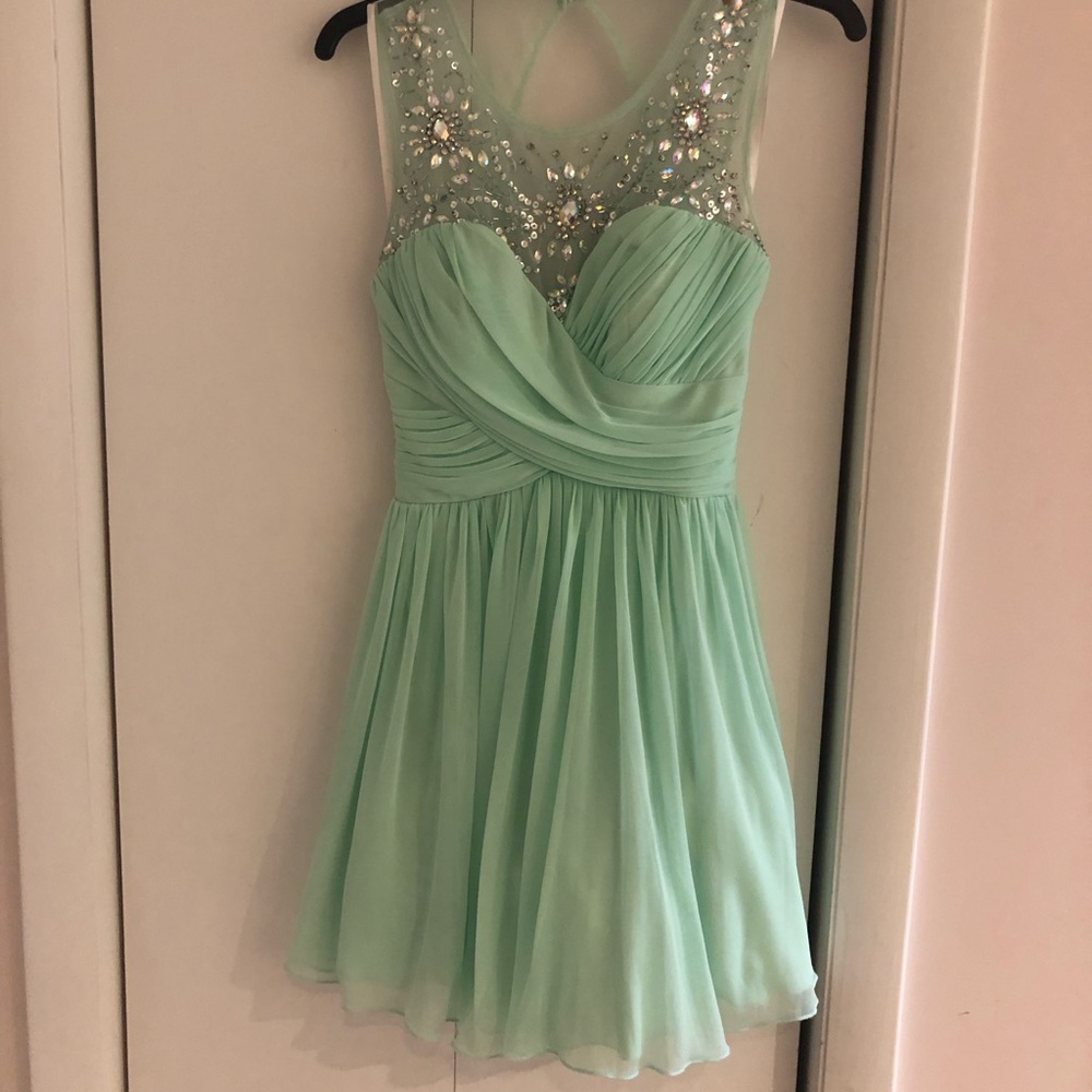Green Deb Dress Size 1/2. Contains Beads & Rhinestones. Has a Button & Zipper.